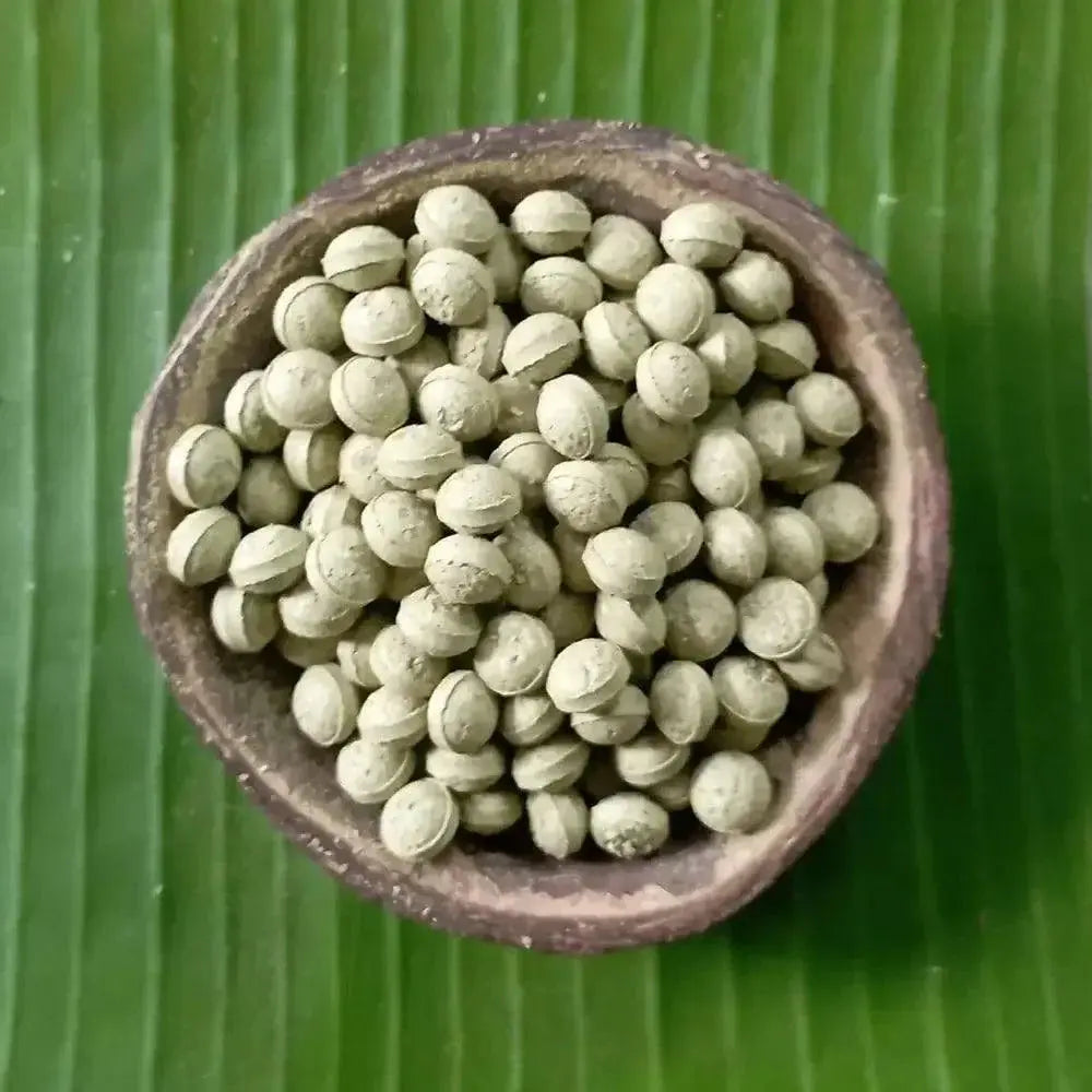 Natural Neem Leaf Supplement in a Bowl on Green Leaf Background